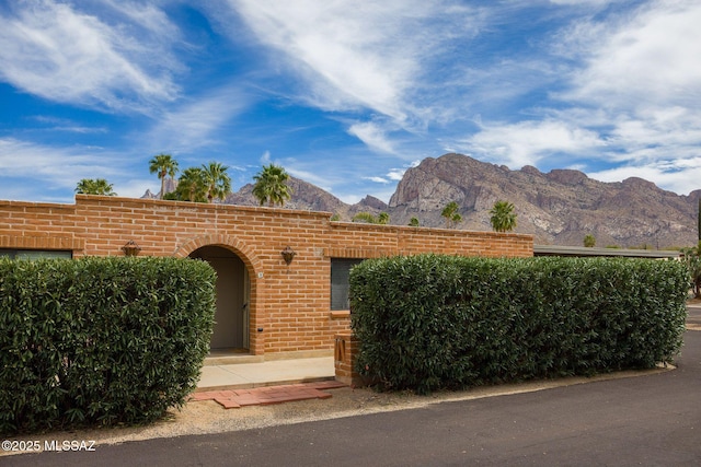 view of front facade featuring brick siding and a mountain view