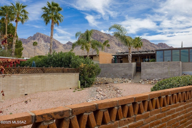 view of yard featuring a fenced front yard and a mountain view