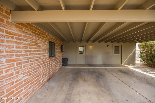 exterior space featuring an attached carport and brick siding