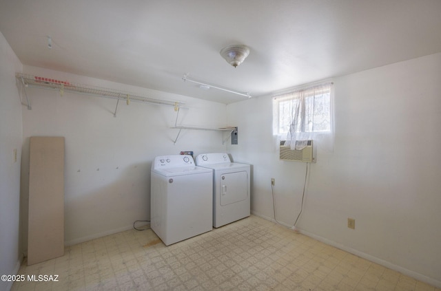 laundry room featuring laundry area, baseboards, light floors, and separate washer and dryer