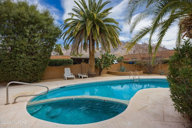 view of pool featuring a fenced backyard, a patio, a fenced in pool, and an in ground hot tub