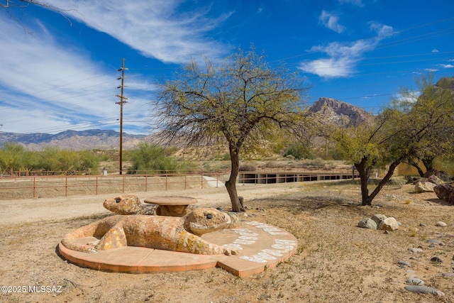 view of yard with fence and a mountain view