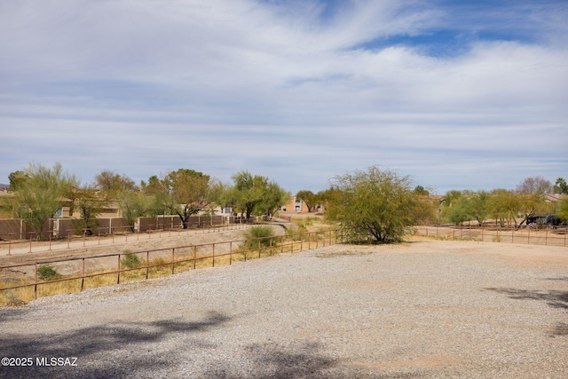 view of yard featuring a rural view and fence