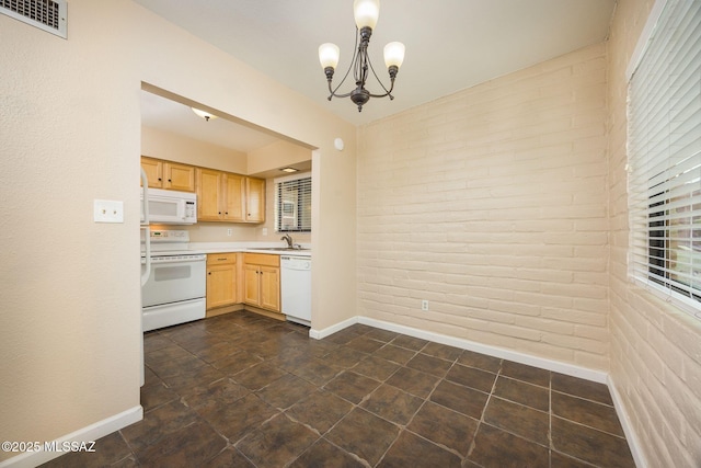 kitchen featuring light brown cabinets, a notable chandelier, white appliances, a sink, and light countertops