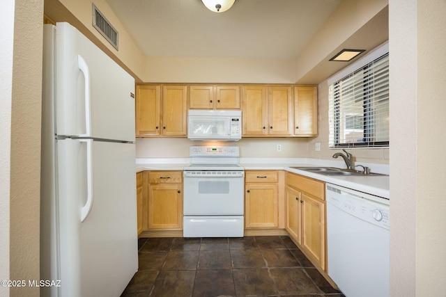 kitchen with white appliances, visible vents, light countertops, and a sink