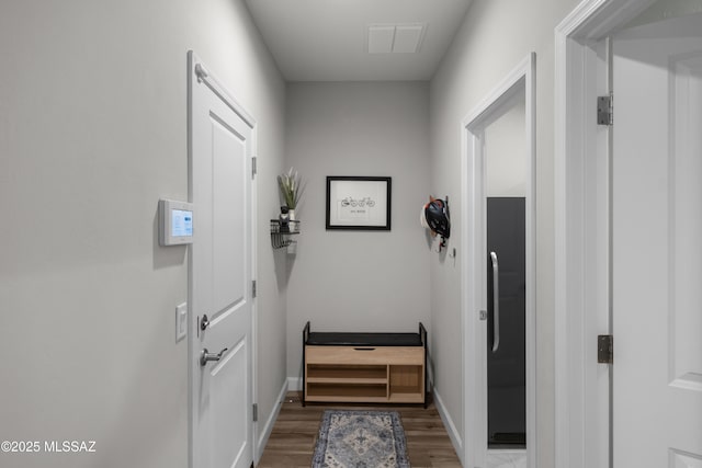 doorway featuring light wood-style flooring, visible vents, and baseboards