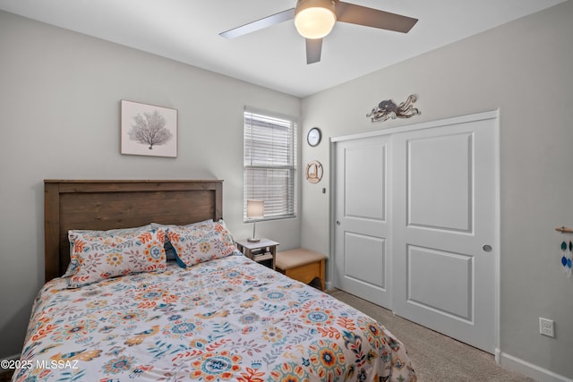 carpeted bedroom with a closet, a ceiling fan, and baseboards