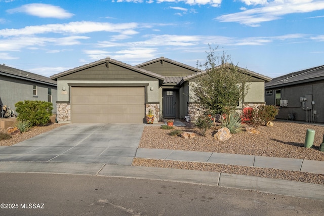 single story home featuring stone siding, driveway, a tiled roof, and an attached garage