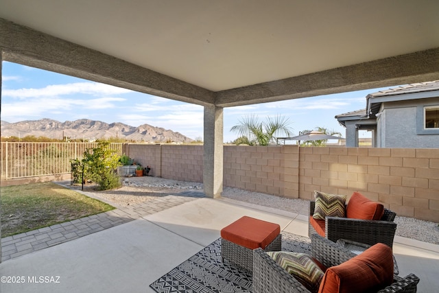 view of patio / terrace with a fenced backyard and a mountain view