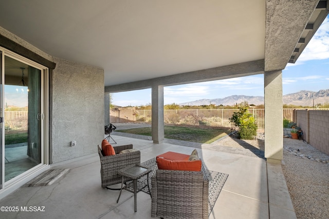 view of patio / terrace with a fenced backyard and a mountain view