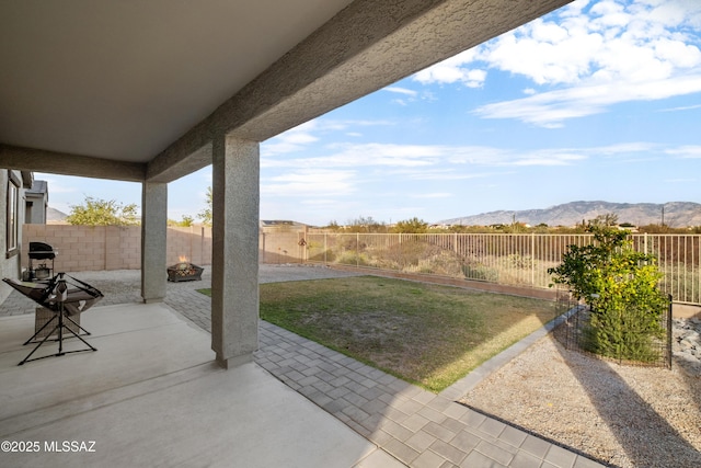 view of patio / terrace featuring a fenced backyard and a mountain view