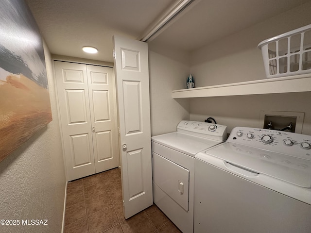 laundry area with laundry area, independent washer and dryer, and dark tile patterned floors