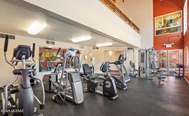 gym featuring a textured ceiling and visible vents