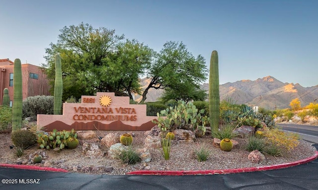 community sign with a mountain view