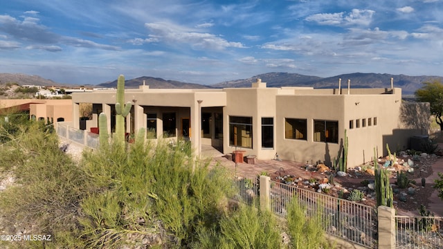 7541 E Crested Saguaro Pl, Tucson, AZ 85750 - back of house featuring a mountain view, stucco siding, and a patio