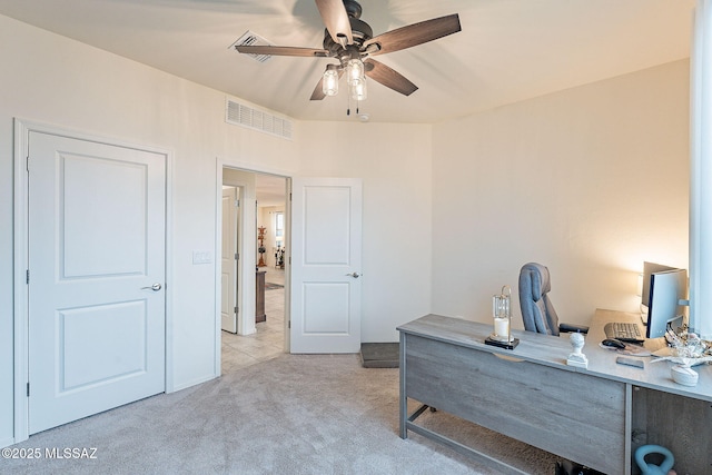 office with a ceiling fan, visible vents, and light colored carpet