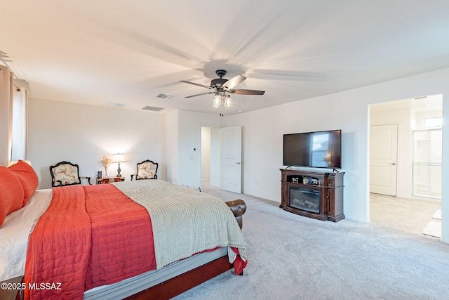 bedroom with a glass covered fireplace, carpet flooring, ceiling fan, and visible vents