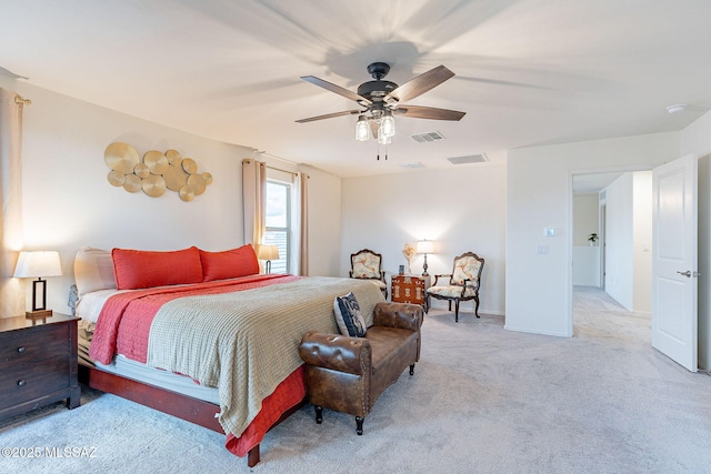 bedroom featuring a ceiling fan, light colored carpet, visible vents, and baseboards