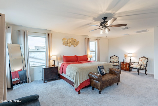 carpeted bedroom featuring baseboards, visible vents, and a ceiling fan