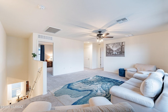 living area with visible vents and light carpet