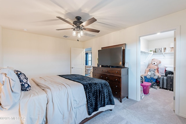 carpeted bedroom with ceiling fan and visible vents