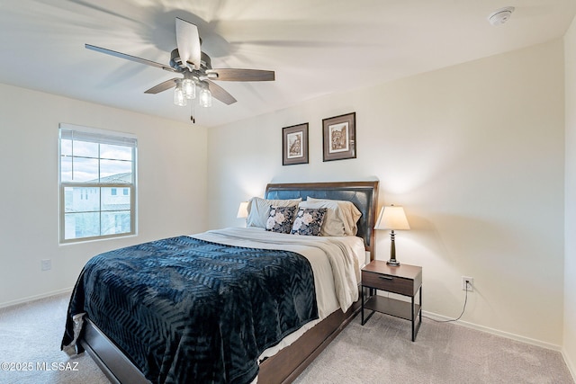 carpeted bedroom featuring ceiling fan and baseboards