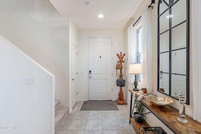 entryway featuring stairway and light tile patterned floors