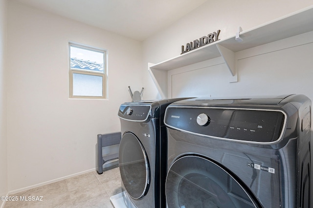 laundry room with laundry area, baseboards, washer and clothes dryer, and light tile patterned flooring