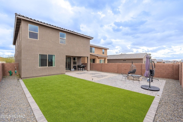 rear view of property with a patio area, a fenced backyard, and stucco siding