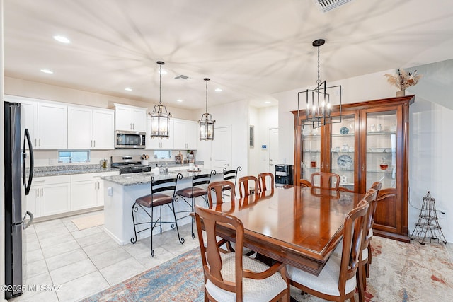 dining room featuring light tile patterned floors, an inviting chandelier, visible vents, and recessed lighting