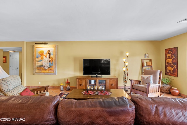 tiled living area featuring visible vents and baseboards