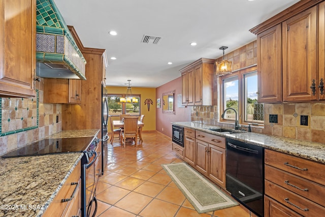 kitchen with light tile patterned floors, visible vents, brown cabinets, black appliances, and a sink