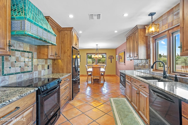 kitchen featuring black appliances, a sink, visible vents, and brown cabinets