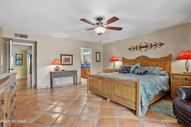 bedroom with light tile patterned floors, connected bathroom, a ceiling fan, visible vents, and baseboards