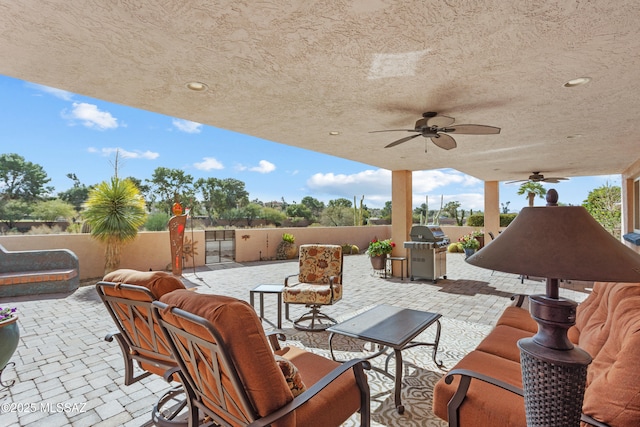 view of patio featuring a fenced backyard, a grill, and ceiling fan