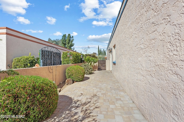 view of home's exterior with fence and stucco siding