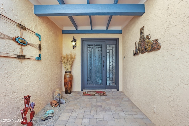 entrance to property with stucco siding