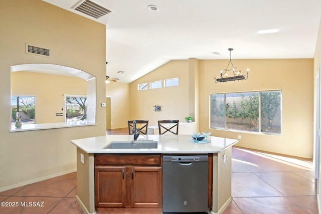 kitchen featuring stainless steel dishwasher, light tile patterned floors, visible vents, and a sink