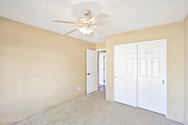 unfurnished bedroom featuring carpet flooring, a closet, and ceiling fan