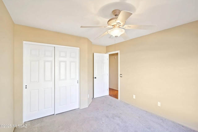 unfurnished bedroom featuring a closet, carpet, and a ceiling fan