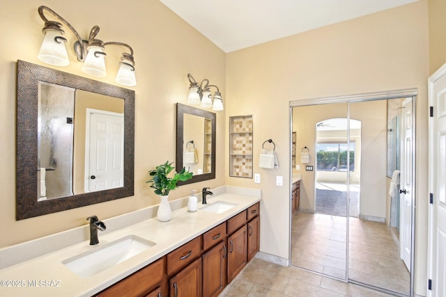 full bath with a sink and double vanity