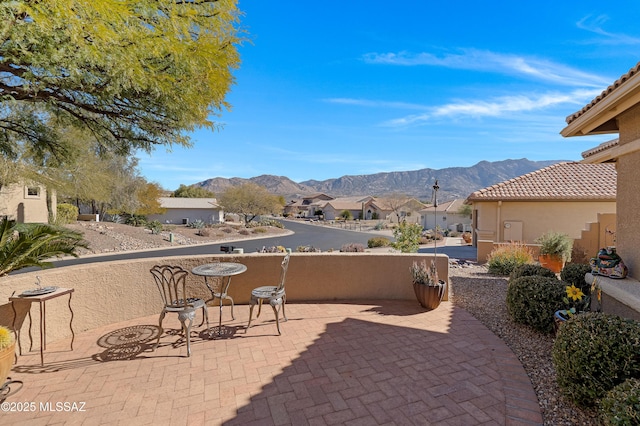 view of patio featuring a mountain view and a residential view