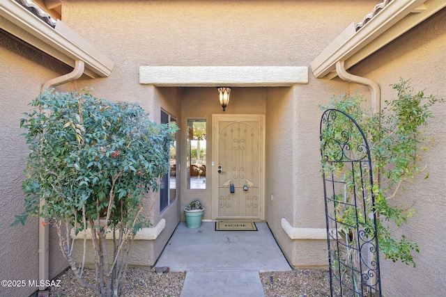 property entrance with stucco siding