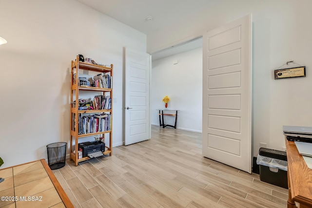 misc room with baseboards and wood tiled floor