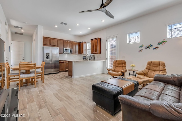 living room featuring recessed lighting, light wood-style floors, visible vents, and ceiling fan