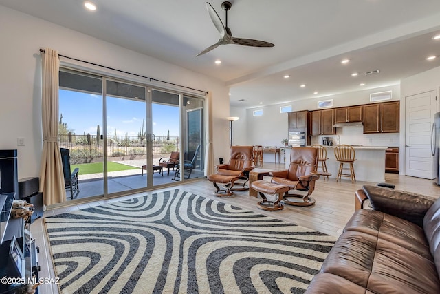 living room with recessed lighting, ceiling fan, visible vents, and light wood-style floors