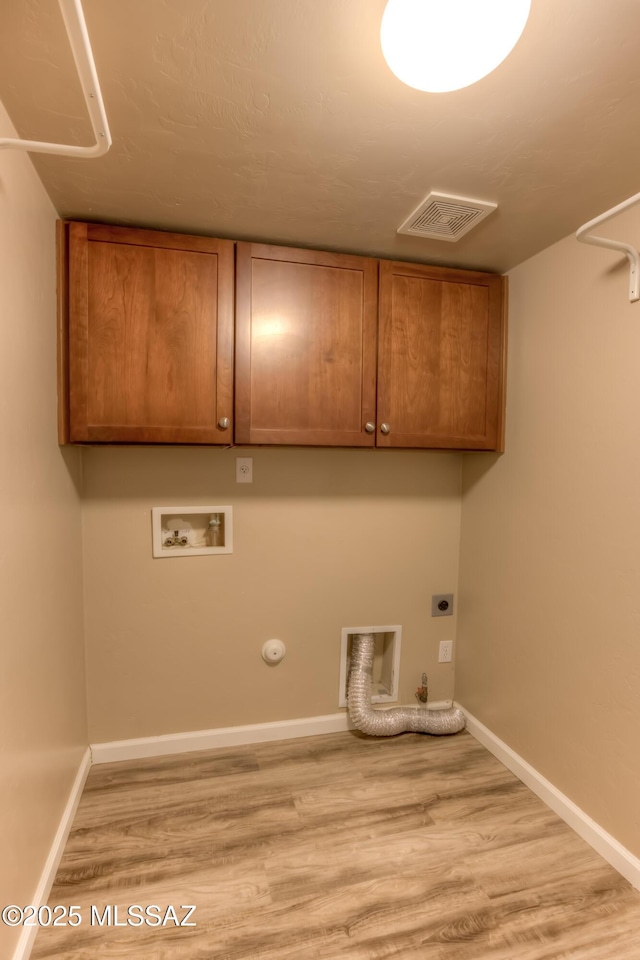 laundry room featuring visible vents, washer hookup, hookup for a gas dryer, cabinet space, and hookup for an electric dryer