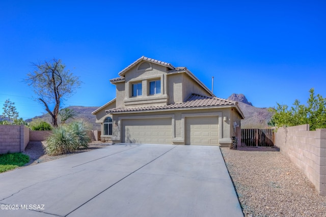 view of front facade with stucco siding, a tile roof, fence, concrete driveway, and an attached garage