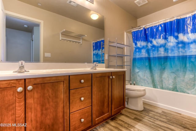 full bathroom with wood finished floors, visible vents, and a sink