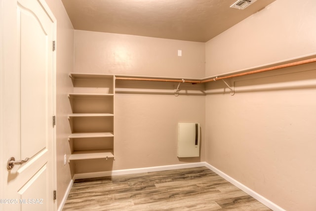 spacious closet with visible vents and wood finished floors